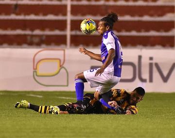 Leonel Morales pasa con dificultad al zaguero Federico Pereyra.