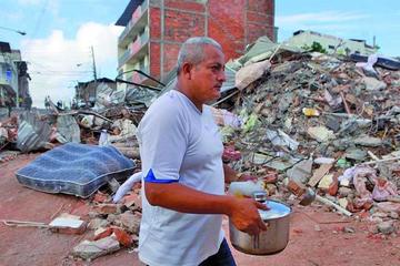 Un hombre lleva café colombiano a los organismos de rescate que trabajan en una de las zonas del desastre de Tarqui en M