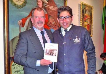 Gleen Murray exhibe el texto junto al presidente del encuentro Daniel Oropeza.
