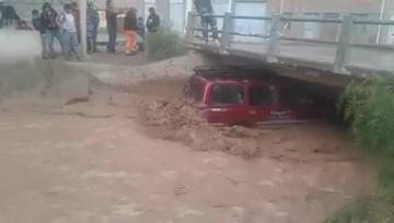 Una torrencial lluvia arrastra un vehículo