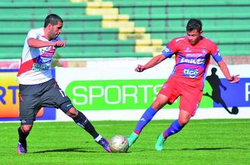 Aldo Paniagua, de Nacional, y Marcelo Gomes, de la U, disputan el balón.