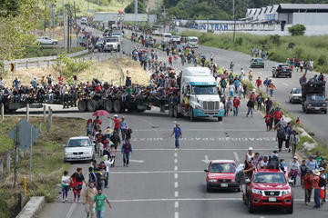 Migrantes hondureños suben a vehículos que se encuentran en el camino para continuar otro tramo del territorio mexicano.
