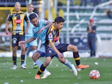 Diego Wayar, del Tigre, gana la pelea por la pelota. 