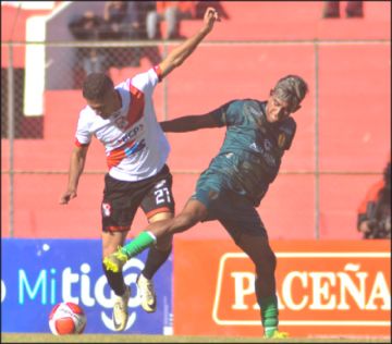 Miyhel Ortiz (i) y Matías Noble se enfrentan por el balón.