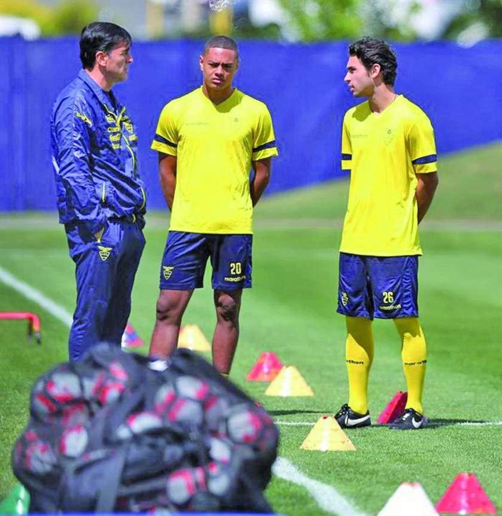 El seleccionador Gustavo Quinteros (i) conversa con el jugador Carlos Gruezo (c).