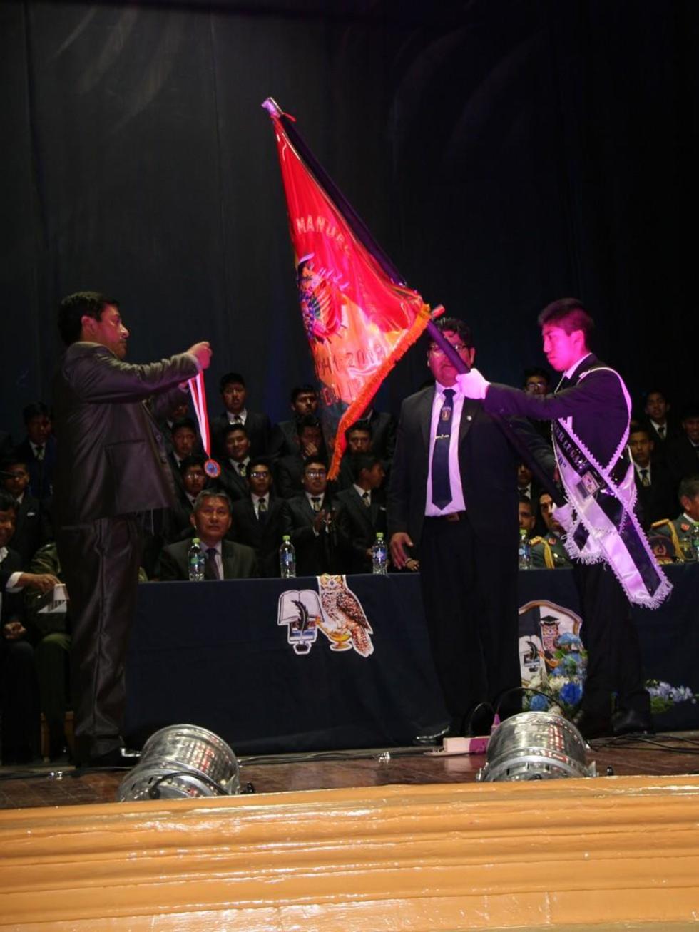 El gobernador impone la medalla al estandarte del establecimiento.